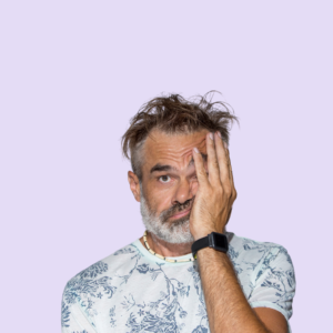 Middle-aged man with a beard against a lilac background